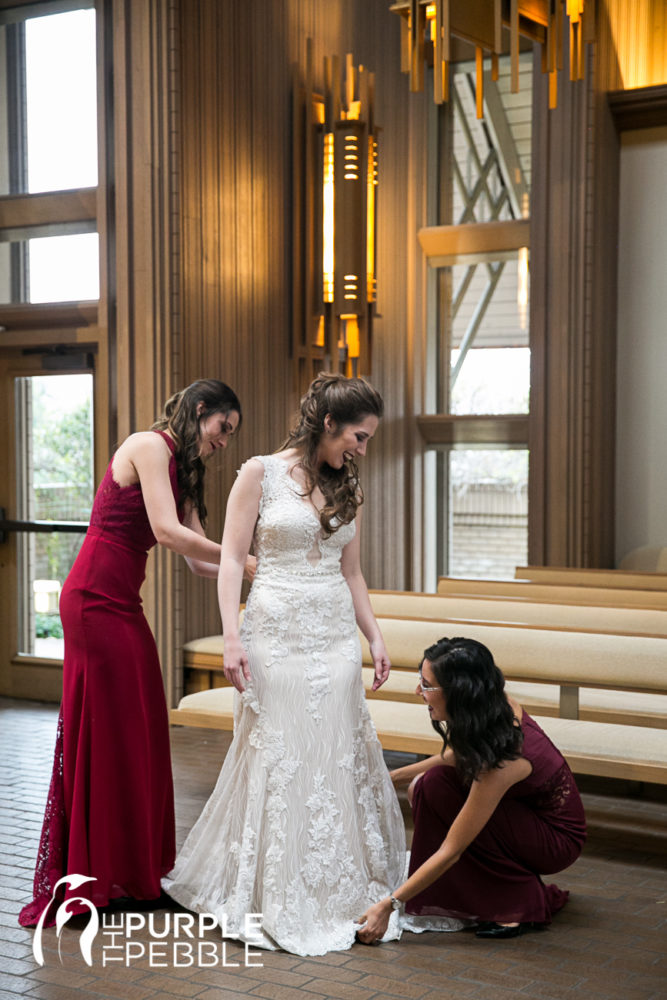 Bridesmaids helping their bride get ready for her special day