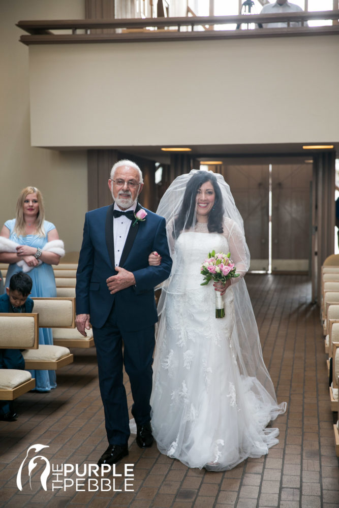 Bride comes down the aisle with her father