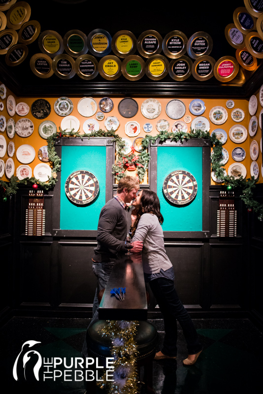 couple playing darts engagement photography